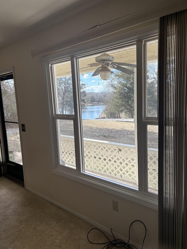 details with a water view, carpet flooring, and ceiling fan