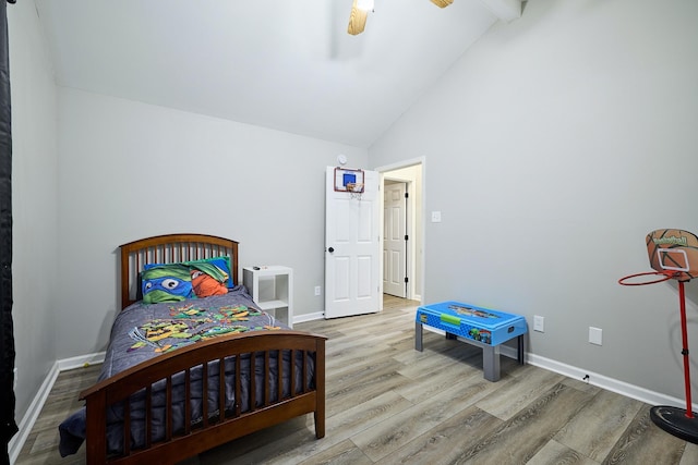 bedroom featuring beamed ceiling, high vaulted ceiling, ceiling fan, and light wood-type flooring