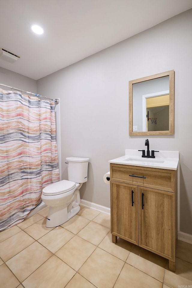 bathroom featuring vanity, tile patterned floors, and toilet