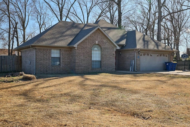 view of front of house with a garage and a front lawn