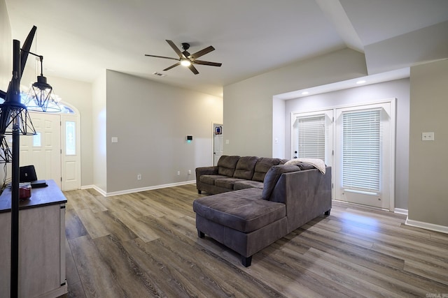 living room with ceiling fan and dark hardwood / wood-style flooring