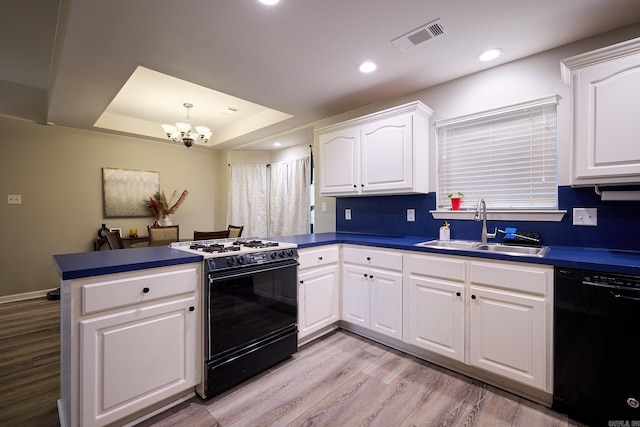 kitchen featuring gas stove, sink, white cabinetry, dishwasher, and kitchen peninsula