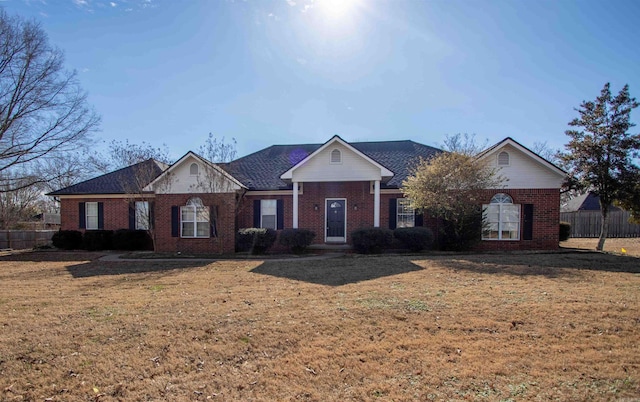 ranch-style home featuring a front yard