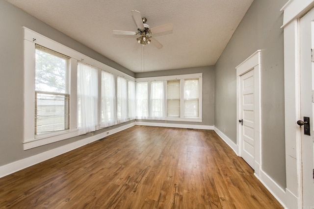 unfurnished sunroom featuring ceiling fan