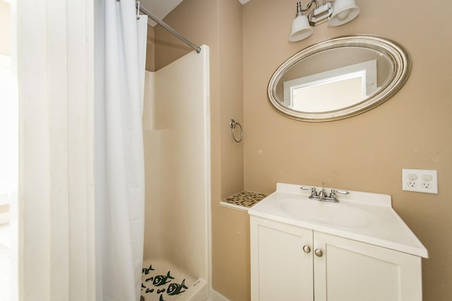 bathroom featuring vanity and a shower with shower curtain