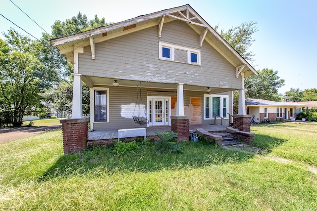 view of front of house with a porch and a front yard