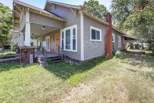 view of property exterior featuring a porch and a yard