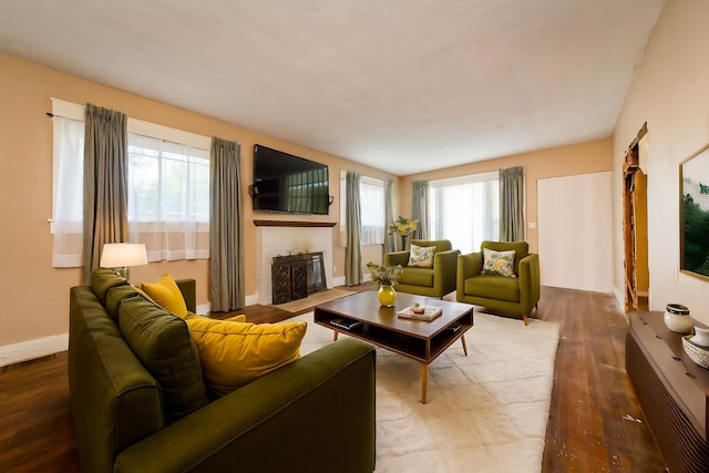 living room with hardwood / wood-style floors and a fireplace