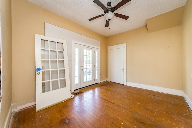 spare room featuring ceiling fan, hardwood / wood-style floors, and a textured ceiling