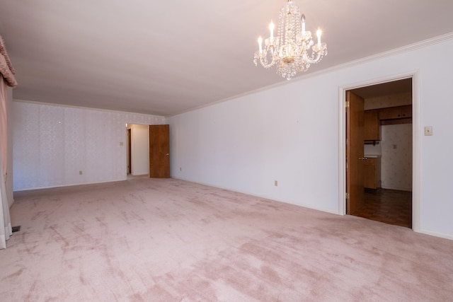 carpeted spare room featuring crown molding and a chandelier