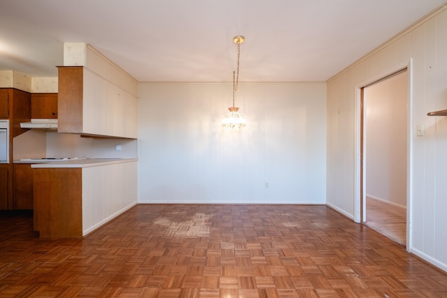 kitchen with hanging light fixtures, crown molding, and parquet floors