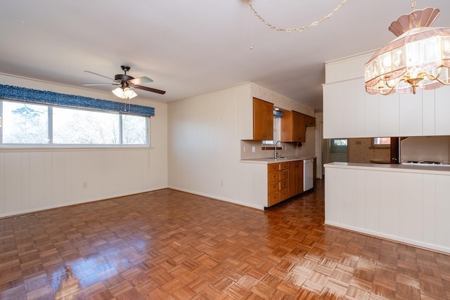 interior space with ceiling fan with notable chandelier, refrigerator, sink, parquet floors, and stainless steel dishwasher