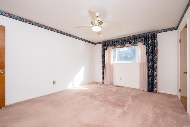 carpeted empty room featuring ceiling fan