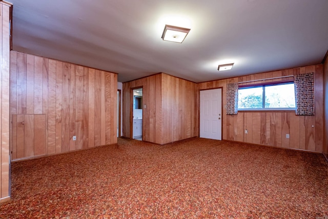 unfurnished room featuring wood walls