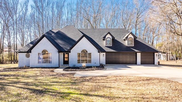 view of front of property featuring a garage and a front lawn