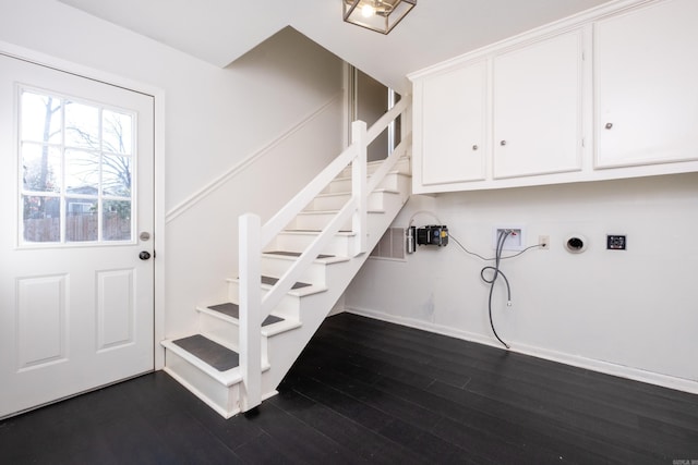 stairway with baseboards and wood finished floors