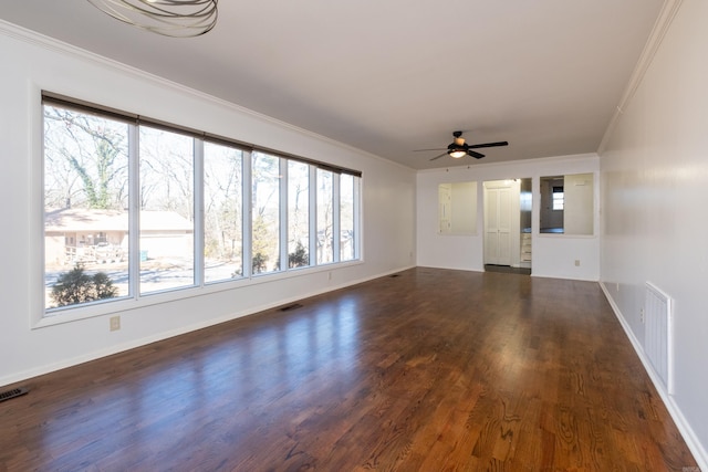 unfurnished living room with ornamental molding, visible vents, and dark wood finished floors