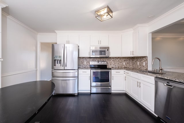 kitchen featuring white cabinetry, appliances with stainless steel finishes, sink, and light stone counters