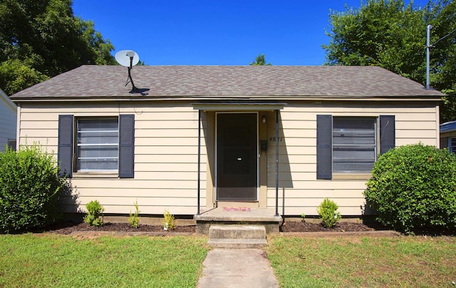 bungalow-style house featuring a front yard