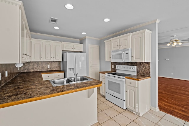 kitchen featuring white cabinets, light tile patterned floors, kitchen peninsula, crown molding, and white appliances