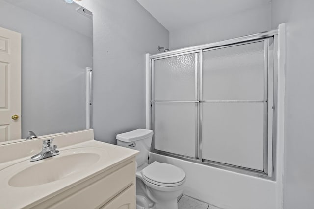 full bathroom with tile patterned floors, vanity, toilet, and combined bath / shower with glass door