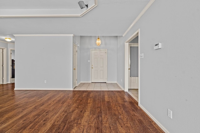 foyer entrance featuring hardwood / wood-style flooring and ornamental molding