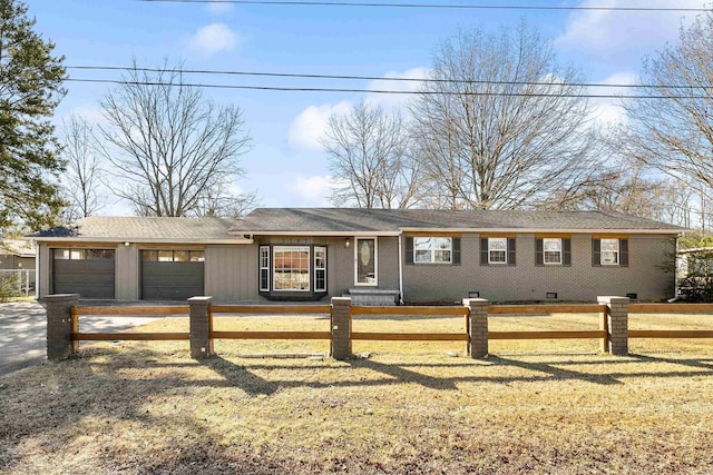 ranch-style house featuring a garage and a front yard