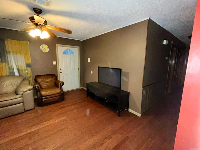 living room with wood-type flooring, ceiling fan, and a textured ceiling