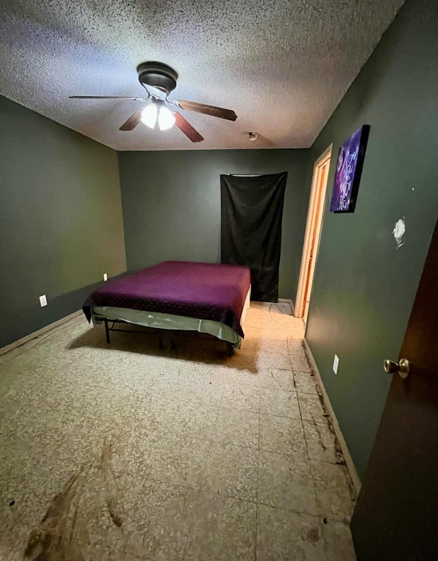 bedroom featuring a textured ceiling and ceiling fan