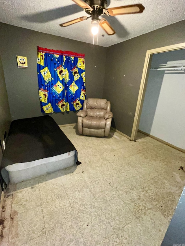 bedroom with a textured ceiling, a closet, and ceiling fan