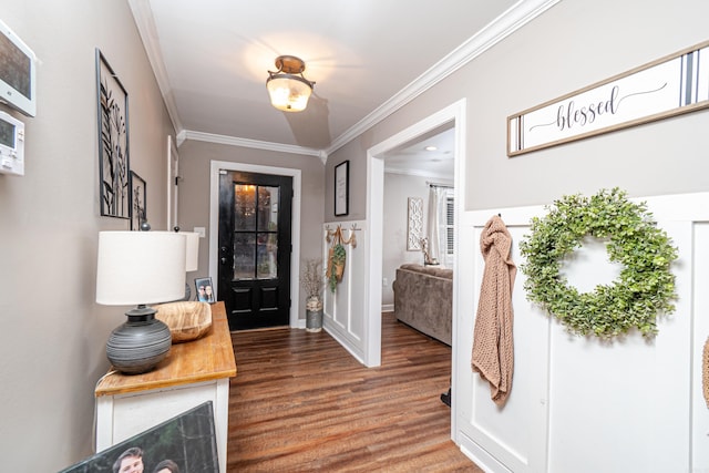 entrance foyer with crown molding and hardwood / wood-style floors