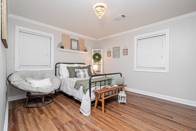 bedroom with ornamental molding and hardwood / wood-style floors