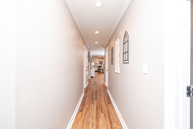 corridor featuring hardwood / wood-style floors and crown molding