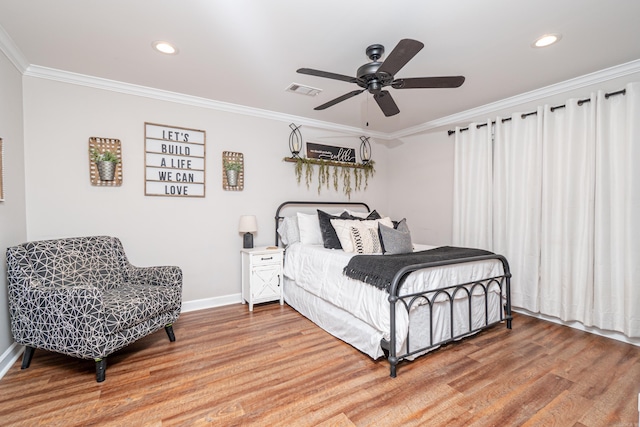 bedroom featuring hardwood / wood-style flooring, ceiling fan, and ornamental molding