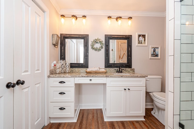 bathroom with crown molding, wood-type flooring, vanity, and toilet