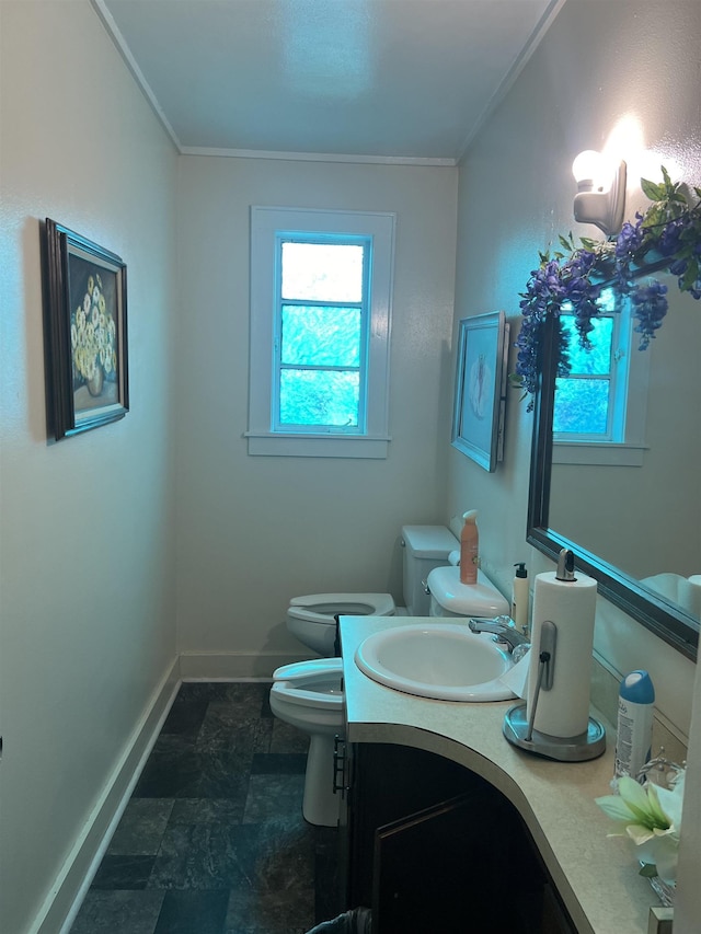 bathroom with ornamental molding, a bidet, vanity, and toilet