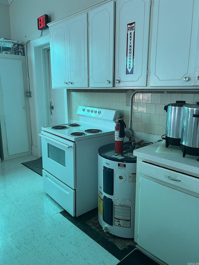 kitchen featuring stove, white cabinetry, and tasteful backsplash