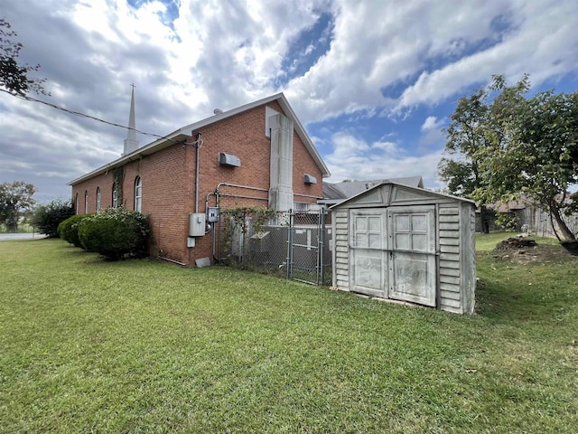 view of side of home featuring a shed and a lawn