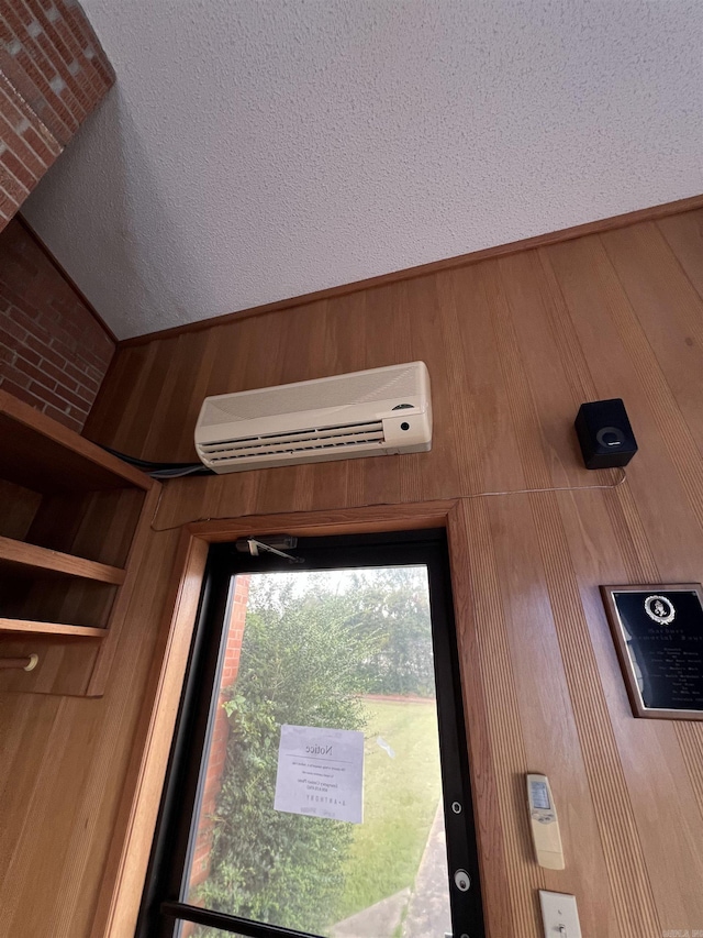 room details with a wall mounted air conditioner and wooden walls