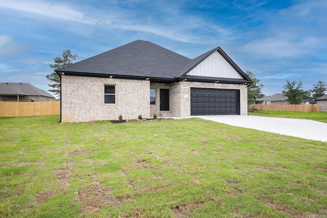 view of front of property with a garage and a front lawn