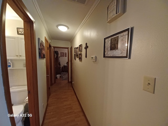 corridor featuring crown molding and hardwood / wood-style flooring