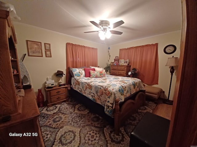 bedroom featuring ornamental molding and ceiling fan