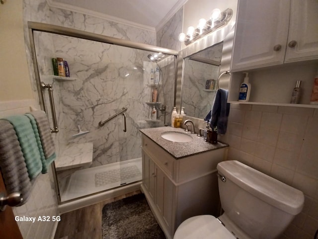 bathroom with vanity, tile walls, an enclosed shower, and crown molding