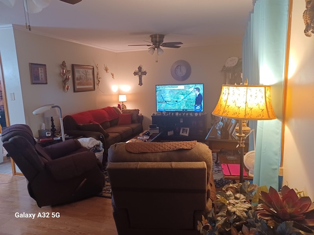 living room featuring crown molding, ceiling fan, and hardwood / wood-style flooring