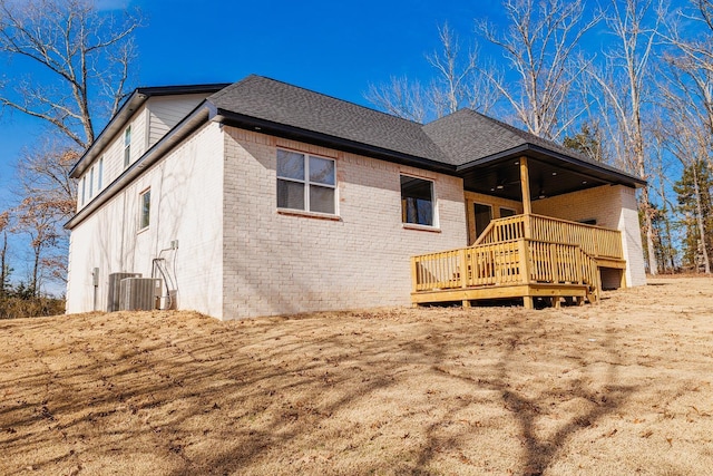 back of house with central AC unit and a deck