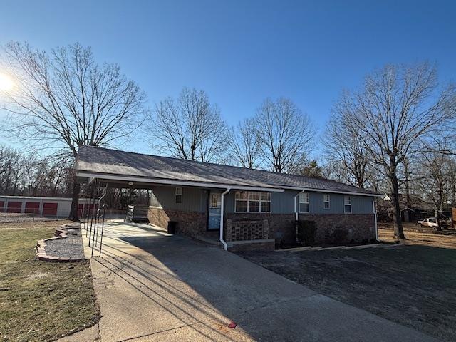 ranch-style home with a front yard and a carport