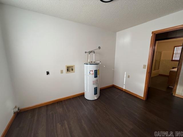 laundry room with washer hookup, dark hardwood / wood-style floors, electric water heater, and a textured ceiling