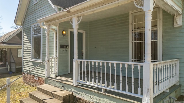 view of exterior entry with a porch