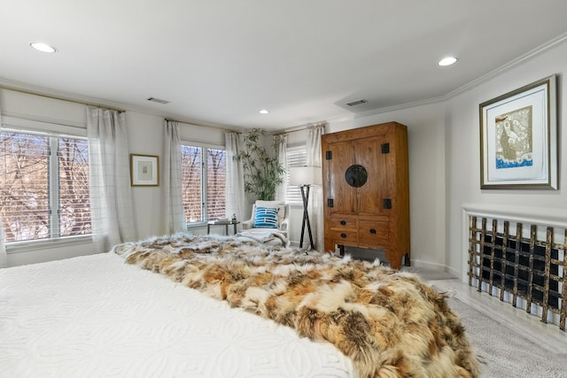 bedroom featuring ornamental molding and multiple windows