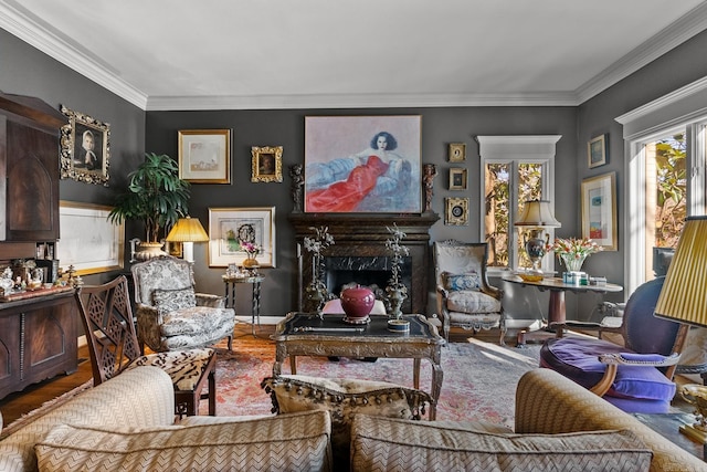 living room featuring hardwood / wood-style flooring, crown molding, and a fireplace